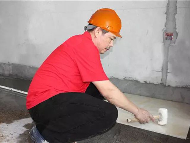 5鋪貼地磚時，磚的背面朝上批刮水泥油，并按箭頭所指方向統(tǒng)一鋪貼，用橡皮錘從中到邊，由重到輕敲實(shí).jpg